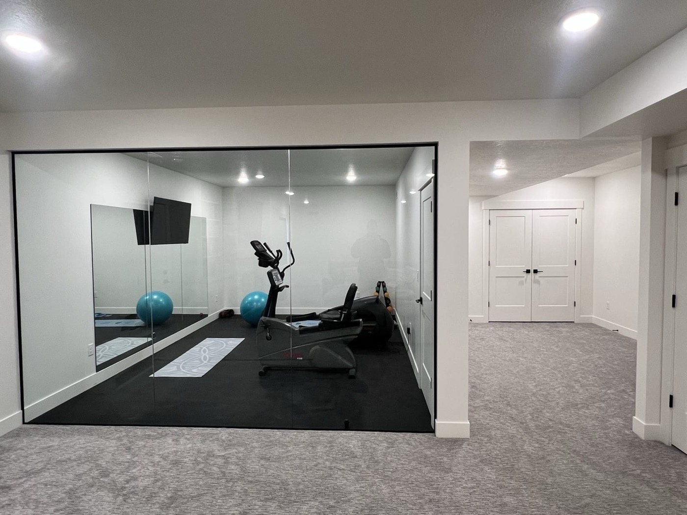 Open concept finished basement in Utah County by Rocky Mtn Remodel